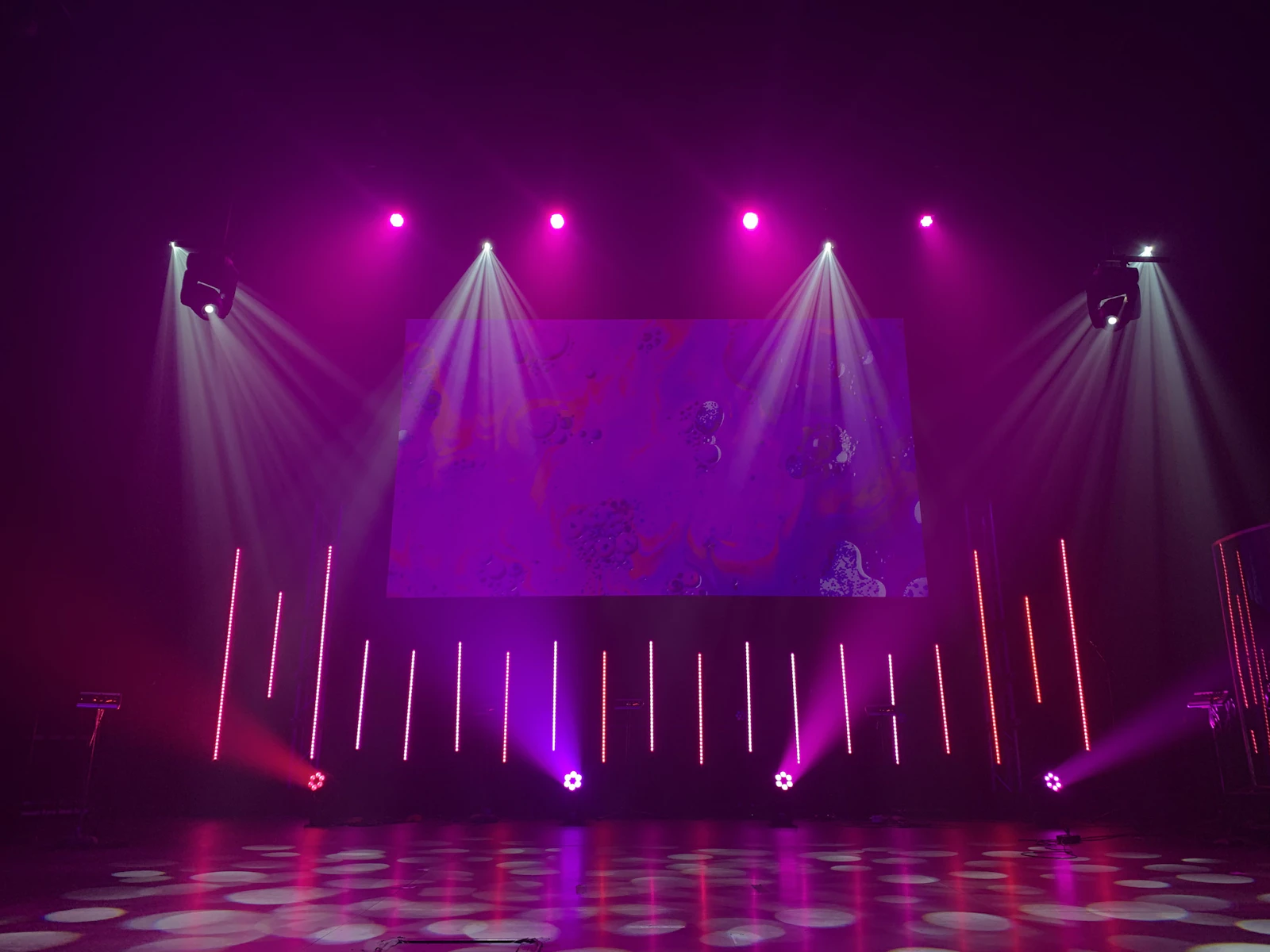 Empty stage lit by light bars